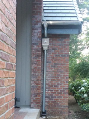 Zinc rounded downspouts with a collector box - Amigo Gutters
